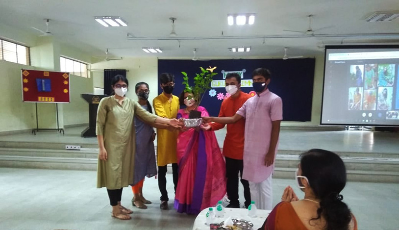 Students gifting the ceremonious sapling to Principal Dr. Archana Mishra